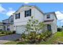Two-story home with a two car garage, a teal entry door and professionally landscaped yard at 10245 Park Estates Ave, Orlando, FL 32836