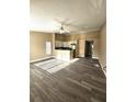 Open-concept living space with modern wood-look flooring, connecting the living and kitchen areas at 1025 Clovercrest Rd, Orlando, FL 32811
