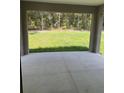 Covered patio offers a serene outdoor space with views of the lush green backyard at 10641 Sw 110Th Ct, Dunnellon, FL 34432