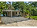 A charming single-story home with a covered carport and well-maintained landscaping at 11 Plumosa Ave, Casselberry, FL 32707