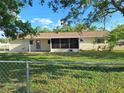 Fenced backyard features a screened-in porch and established landscaping at 11282 Sw 62Nd Avenue Rd, Ocala, FL 34476