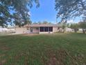 View of the backyard with a screened-in lanai and a fenced-in yard at 11282 Sw 62Nd Avenue Rd, Ocala, FL 34476
