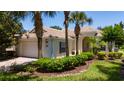 Charming single-story home featuring a tile roof, manicured landscaping, and a welcoming entrance at 12185 Obelia Ln, Orlando, FL 32827