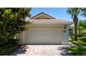 Spacious two-car garage with brick paved driveway, complementing the home's curb appeal at 12185 Obelia Ln, Orlando, FL 32827