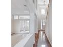 Bright foyer featuring tiled floors and wood accents, leading to a room with glass paneled doors and staircase at 13156 Hatherton Cir, Orlando, FL 32832