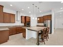 Spacious kitchen with an island, granite countertops, stainless steel appliances, and ample cabinet space at 14078 Alafaya Oak Bnd, Orlando, FL 32828