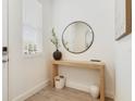 Bright foyer features a modern console table, round mirror, and stylish decor at 14655 Erice Ave, Clermont, FL 34714