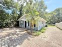 Charming single story home with brick paved drive and palm tree in yard at 1523 S Mellonville Ave, Sanford, FL 32771