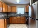 Well-lit kitchen with stainless steel appliances and granite countertops at 1614 Christa Ct, St Cloud, FL 34772
