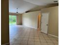 Neutral living area featuring tile floors and sliding glass doors to the backyard at 1614 Christa Ct, St Cloud, FL 34772