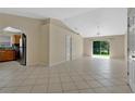 Bright and airy living room with tile floors, ceiling fan, and sliding door to the yard at 1614 Christa Ct, St Cloud, FL 34772