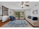 Bright living room with wood floors, a large window, and an open layout perfect for modern living at 1830 W Clinton Dr, St Cloud, FL 34769