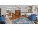 Open concept living space with hardwood floors, stylish rug, and plenty of natural light at 1830 W Clinton Dr, St Cloud, FL 34769