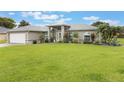 Charming single-story home with a well-manicured lawn and neutral exterior at 2113 Kirkland Lake Dr, Auburndale, FL 33823
