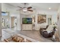 Open concept living room featuring a ceiling fan, and views to the kitchen at 2113 Kirkland Lake Dr, Auburndale, FL 33823