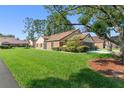 Well-manicured lawn surrounds this inviting home, showcasing its appealing exterior and landscaping at 216 Bermuda Petrel Ct, Daytona Beach, FL 32119