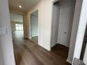 Hallway features wood flooring, neutral paint and an open doorway to the rest of the home at 2322 Daisy Tree Rd, St Cloud, FL 34771