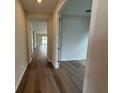Entryway features wood flooring, neutral paint and an open doorway to the rest of the home at 2322 Daisy Tree Rd, St Cloud, FL 34771