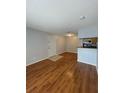 Living room with wood floors, a view into the kitchen and the front door with a tiled landing at 238 Afton Sq # 204, Altamonte Springs, FL 32714