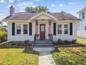 Charming home featuring a landscaped front yard, sidewalk, and quaint details at 2505 Amherst Ave, Orlando, FL 32804