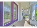 Inviting front porch with a decorative glass door, columns, and cozy bench at 4394 Devon Ct, Kissimmee, FL 34746