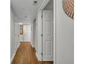 Hallway with wood flooring, white walls, and a door ajar at 5207 S Atlantic Ave # 225, New Smyrna Beach, FL 32169