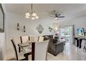 Elegant dining area with modern lighting and stylish decor, adjacent to the living room, ideal for Gathering gatherings at 528 Terra Lago St, Davenport, FL 33897