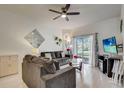 Comfortable living room with a sliding glass door and view of the yard, creating a seamless indoor-outdoor living experience at 528 Terra Lago St, Davenport, FL 33897