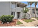 Well-maintained exterior with greenery, stairs, and a charming entrance with a decorative front door at 5635 Blue Shadows Ct # 3, Orlando, FL 32811