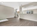Bright living room featuring laminate flooring, neutral walls, and staircase at 7469 Hunters Greene Cir, Lakeland, FL 33810