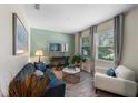 Cozy living room featuring stylish decor, wood-look tile flooring, and ample natural light at 816 Carmillion Ct, Groveland, FL 34736