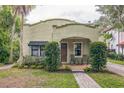 Charming stucco home with a brick walkway, covered porch, and lush landscaping at 1012 W New Hampshire St, Orlando, FL 32804
