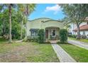 Beautiful craftsman home boasting mature landscaping and a brick walkway leading to a covered porch with rocking chairs at 1012 W New Hampshire St, Orlando, FL 32804