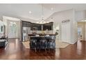 Spacious kitchen boasts dark cabinetry, a large island with seating, and stainless steel appliances at 10146 Pointview Ct, Orlando, FL 32836