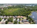 Aerial view of the property showcasing a peaceful neighborhood near a scenic lake at 11218 Rouse Run Cir, Orlando, FL 32817