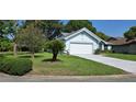 Inviting single-story home boasting a lovely lawn and a convenient two-car attached garage at 11818 Sophia Ln, Orlando, FL 32821