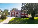 Beautiful two-story home with brick paved driveway, lush lawn, and manicured landscaping at 1254 Shelter Rock Rd, Orlando, FL 32835