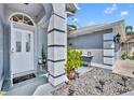 Inviting front entrance with a welcoming doormat, potted plants, and decorative gravel landscaping at 12618 Lakebrook Dr, Orlando, FL 32828