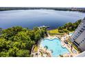 Stunning aerial shot showcasing the community pool and lakefront setting at 13415 Blue Heron Beach Dr # 1503, Orlando, FL 32821