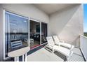 Balcony with lake views, lounge chairs, and table at 13415 Blue Heron Beach Dr # 1503, Orlando, FL 32821