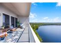 Comfortable condo balcony with seating and beautiful lake and wooded views at 13427 Blue Heron Beach Dr # 2003, Orlando, FL 32821