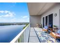 Relaxing condo balcony with furniture, decor, and a stunning view of the lake at 13427 Blue Heron Beach Dr # 2003, Orlando, FL 32821