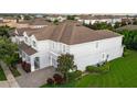 Gray two-story home with a brown roof, well-maintained lawn, and paved driveway to a 2-car garage at 14572 Black Quill Dr, Winter Garden, FL 34787