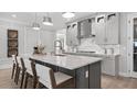 Stylish kitchen featuring a large island with bar seating, modern appliances, and elegant finishes at 1613 Bellagio Loop, Tavares, FL 32778