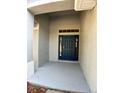 Welcoming front entry with a stylish blue door and covered porch at 1715 Redfin Way, Kissimmee, FL 34759