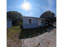 Exterior shot showcasing home with shed, lawn, and driveway at 2031 Warrens Ave, Maitland, FL 32751