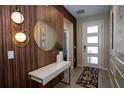Charming foyer with stylish lighting, designer mirror, and modern console table at 2379 Distant Sun Trl, Kissimmee, FL 34747