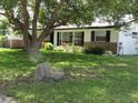Charming single-story home with well-maintained lawn and mature trees at 2632 Derbyshire Rd, Maitland, FL 32751
