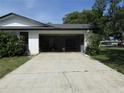 Spacious attached garage with an open door and concrete driveway at 2632 Derbyshire Rd, Maitland, FL 32751