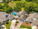 Aerial view of a home with a screened-in pool, lush landscaping, and a serene neighborhood setting at 2652 Bent Hickory Cir, Longwood, FL 32779